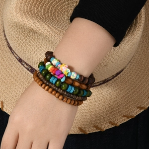 Detail of bohemian layered beaded bracelet set with natural turquoise and turtle charm