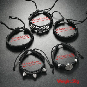 Detail view of 5-piece punk bracelet set with studded leather and cross charms