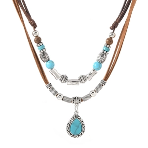 Detail of bohemian double-layer necklace with turquoise beads and silver teardrop pendant
