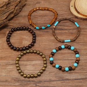 Detail of bohemian multilayered beaded bracelets with wood beads and turquoise stones