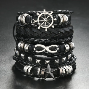 Detail of multi-layer leather bracelets featuring infinity symbol and nautical helm charms