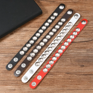 Detail of studded leather bracelets with adjustable snap buttons in multiple colors