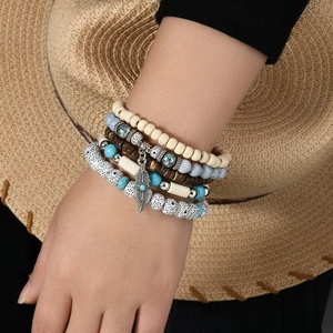 Bohemian multi-layer turquoise beaded bracelet set with a silver feather charm detail