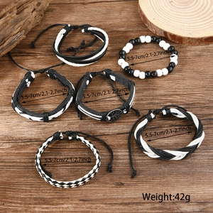 Macro shot of a 6-piece tree of life leather bracelet set with beads and woven bands