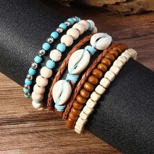 Gros plan d'un ensemble de bracelets bohèmes avec perles turquoise et détails en bois
