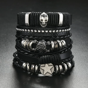 Macro shot of Gothic multi-layer leather bracelets with skull and pentagram charms