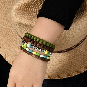 Detail of bohemian multilayer turquoise bead bracelet set with ethnic wood and metal accents