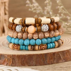 Macro view of bohemian multilayer bracelet set with wood beads and turquoise stones