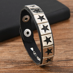Detail of punk leather bracelet featuring silver stars and adjustable metal snap buttons