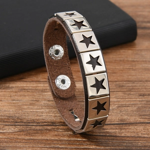 Punk brown leather wristband with silver star-shaped metal studs and adjustable snap buttons
