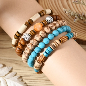 Detail of bohemian multilayer bead bracelet set with turquoise and wooden accents
