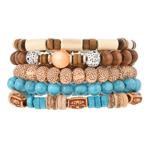 Close-up of bohemian layered beaded bracelets featuring turquoise and wooden textures