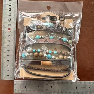 Detail shot of a 6-piece bohemian leather and turquoise beaded bracelet set with scale ruler
