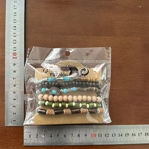 Detail of five-piece bohemian beaded bracelet set with turquoise and wooden beads