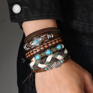 Multilayer leather bracelet set with turquoise stones and vintage charms on a model