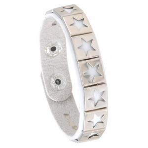 Detail of white leather punk bracelet with silver star cutouts and adjustable snap buttons