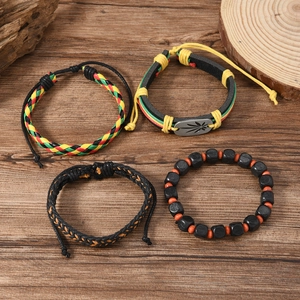 Jamaica-style bracelet set with red, yellow, green weave and maple leaf charm on wood