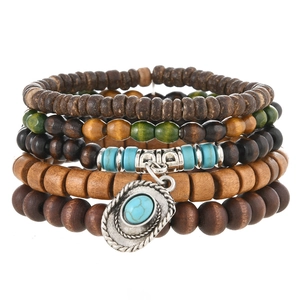 Detail of bohemian multilayer beaded bracelets with a turquoise cowboy hat charm