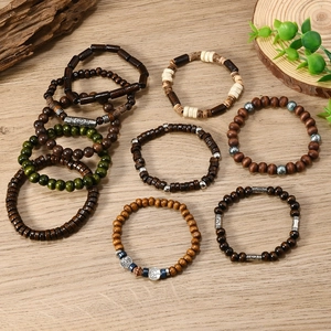Detail of 12-piece bohemian men's wooden beaded stretch bracelets with tree of life charms