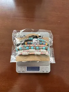 Weight measurement of the multi-layer bohemian beaded bracelet set on an electronic scale