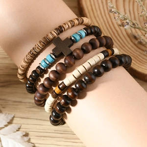 Detail of bohemian multilayer beaded bracelet with wood beads and turquoise cross charm