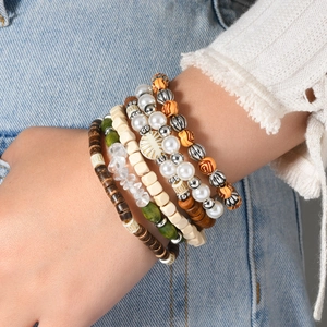 Bohemian multi-layer stretch bracelet with wooden beads and turquoise stones on a wrist