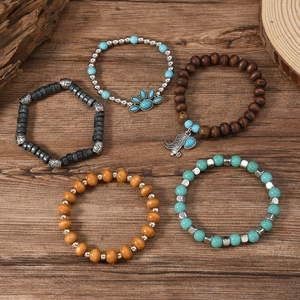 5-piece bohemian beaded bracelet set with wood beads, turquoise, and boot charm on wood
