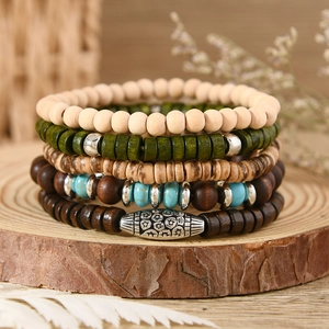 Macro detail of bohemian layered turquoise beaded bracelets on a natural wood stand