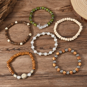 Bohemian multilayer wooden bead bracelet set with stone and sun charm on dark wood