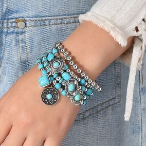 Bohemian multi-layer turquoise beaded bracelet set with silver sun pendants on wrist