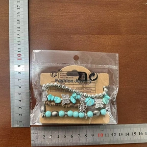 Detail view of Bohemian turquoise beaded bracelet with butterfly pendant and size measurement