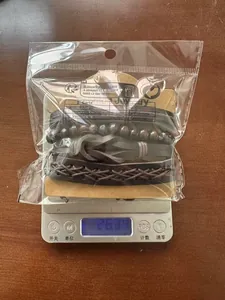 Detailed scale view showing the 26.39g weight of a multilayer woven leather bracelet set
