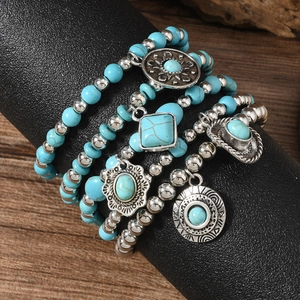 Bohemian multilayer turquoise bead bracelet set with vintage silver charms on display