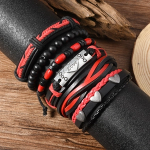 Multilayer leather bracelet set with Love plate and heart charm on a wood stand