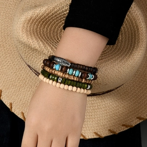 Detail of bohemian five-piece beaded bracelet set with turquoise and engraved metal beads