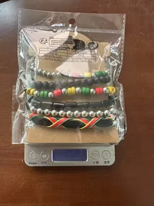 Close-up of Bohemian beaded bracelet set in red, yellow, and green on a digital scale