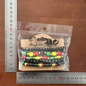 Detail of multi-layer wood beaded bracelet set with red yellow green beads on measuring ruler