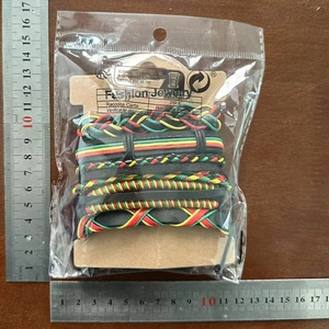 Detailed view of Rasta-style braided leather bracelet set with measuring ruler scales