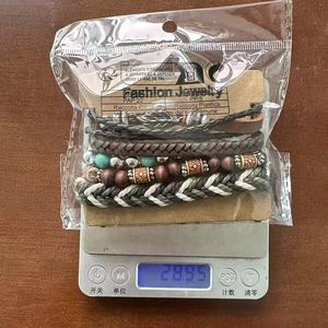 Macro shot of Bohemian multilayer leather bracelets with turquoise beads and leaf charms