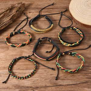 Adjustable 6-piece Rasta braided leather bracelet set on a vintage wood background