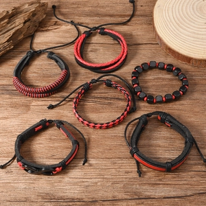 6-piece handmade leather bracelet set with infinity charm and red accents on wood background