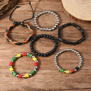 Bohemian beaded bracelet set with red, yellow, and green beads on a wooden background