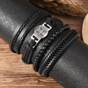 Men's Viking multilayer leather bracelet with Saint Benedict medal on wood stand