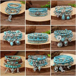Detail of nine Bohemian turquoise bead bracelets with vintage silver ethnic charms