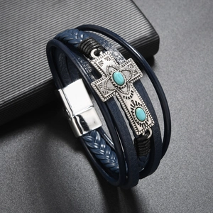 Close-up of multilayer navy leather bracelet with silver cross and turquoise inlay