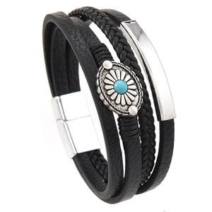 Detailed close-up of multi-layer black leather bracelet with turquoise bead and magnetic clasp
