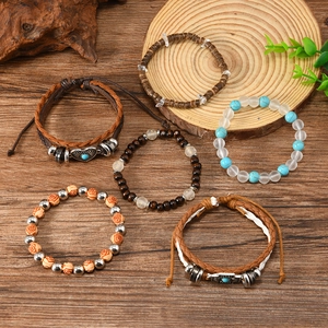 Bohemian 6-piece bracelet set with heart and cross charms on vintage wood background
