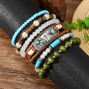 Bohemian multi-layer turquoise bead bracelet set featuring vintage bull head charm on a stand