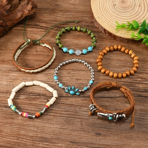 Bohemian multi-layer hand-woven bracelet set with beads and cross charms on wood