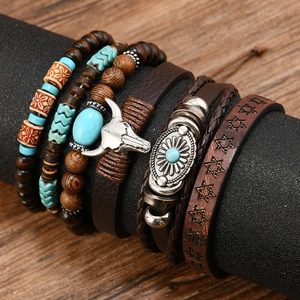 Detail of bohemian leather bracelets with turquoise beads, wooden charms and bull skull pendant